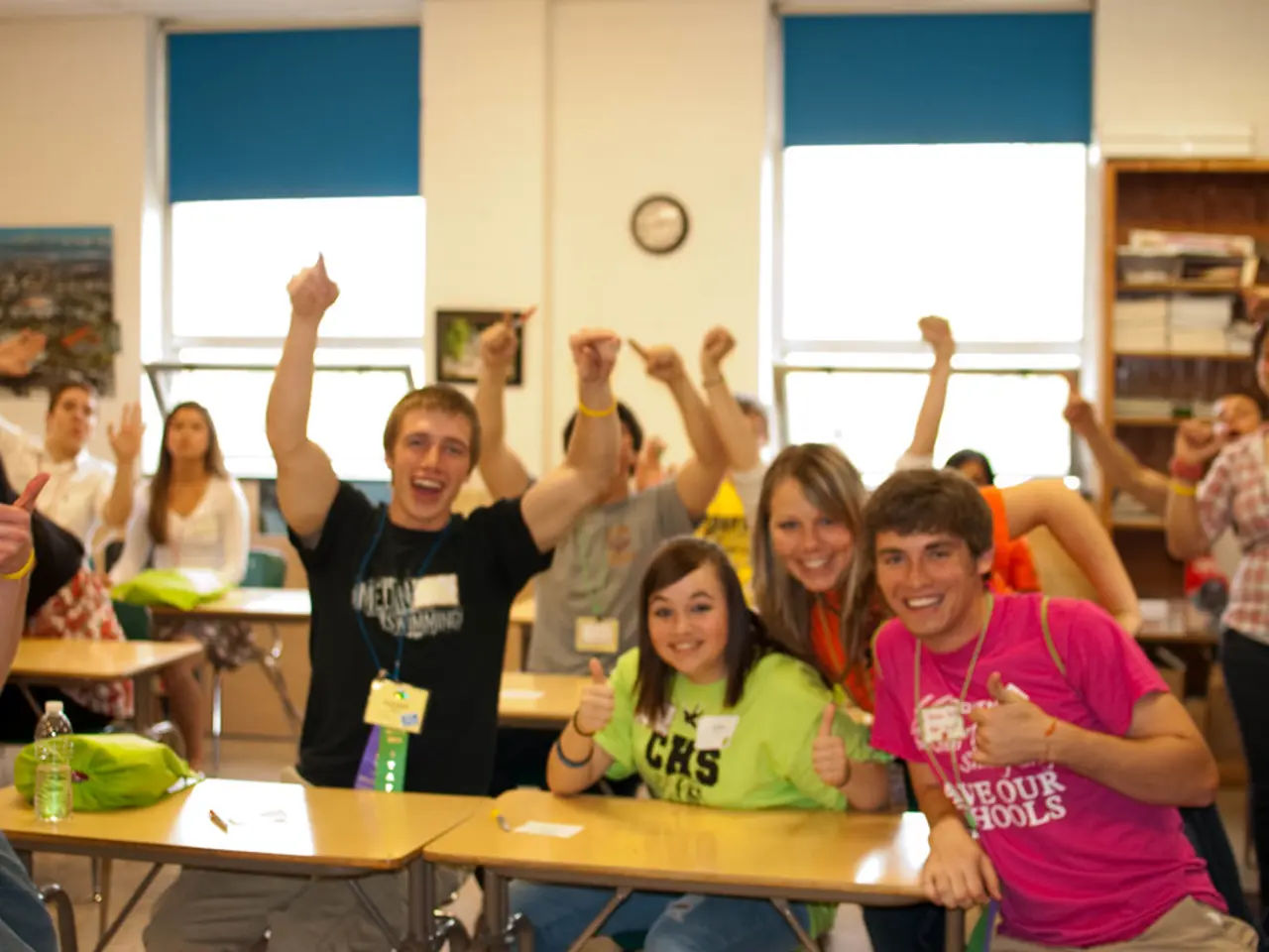 This picture is clicked inside the room. There are many people in this room. The man in black...