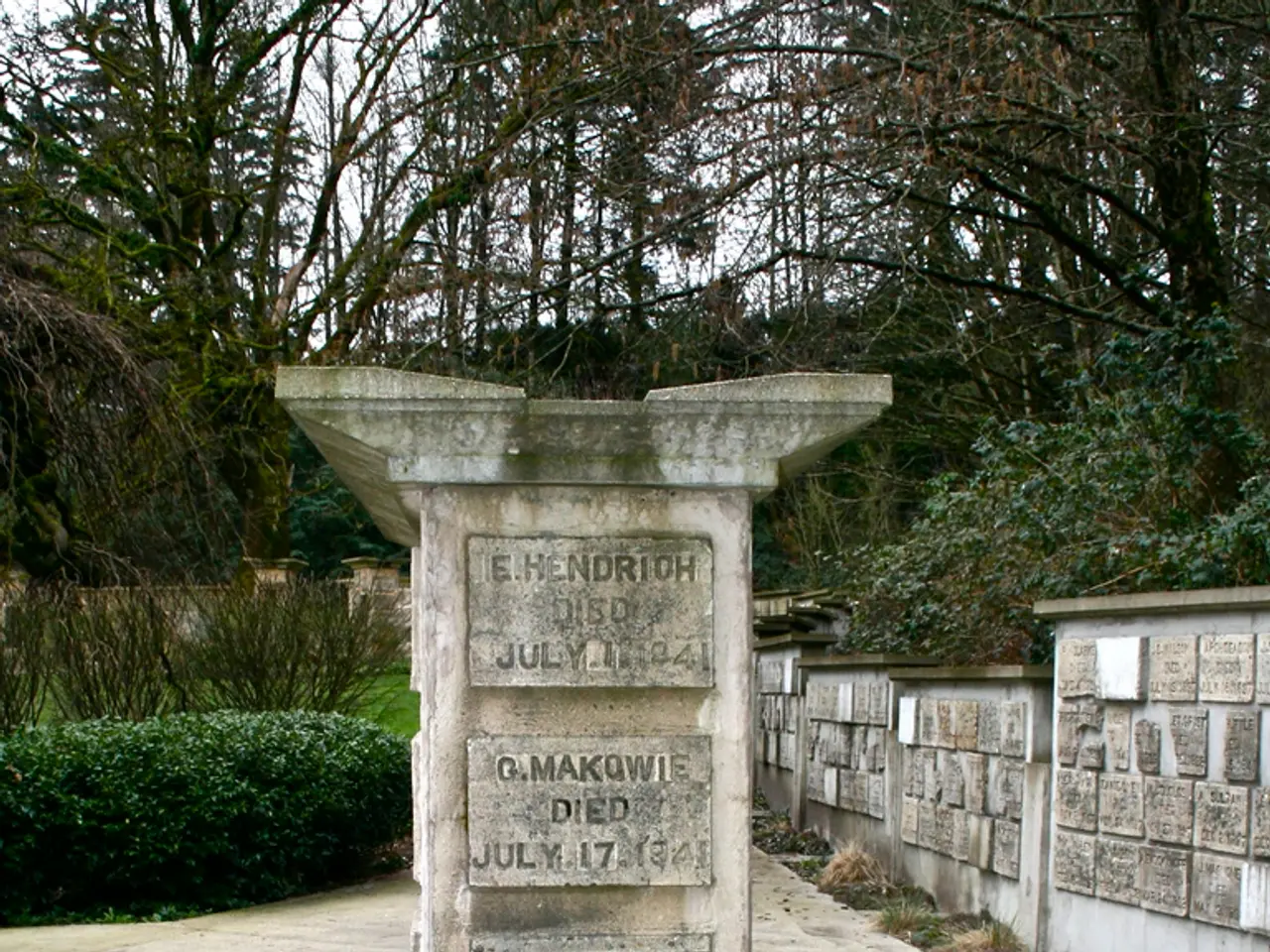 In this image there is a grave, around that grave there is a wall, in the background there are...