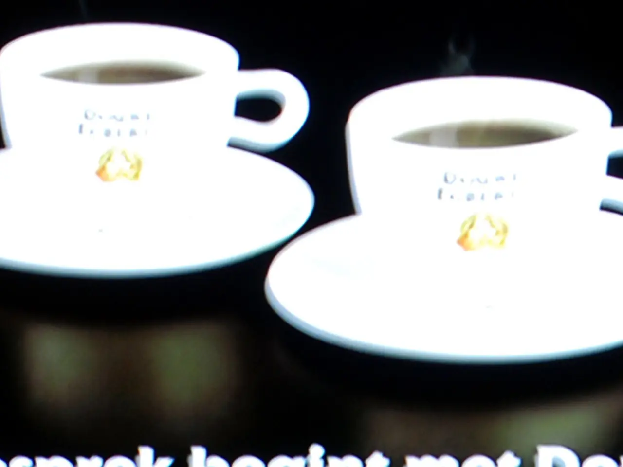 In this image we can see there are cups and saucer with drink. And there is a text written on it.