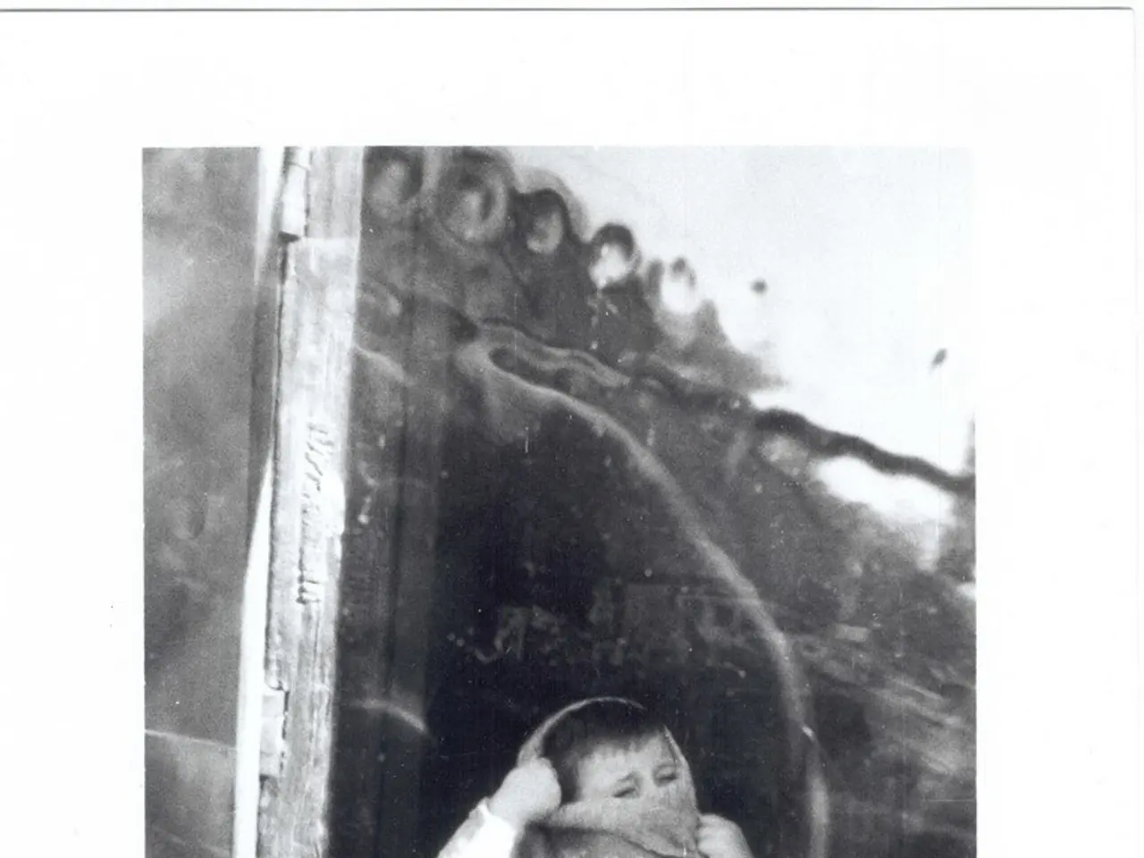 This image consists of a kid wearing a sweater. In the background, there is wall on which there is...