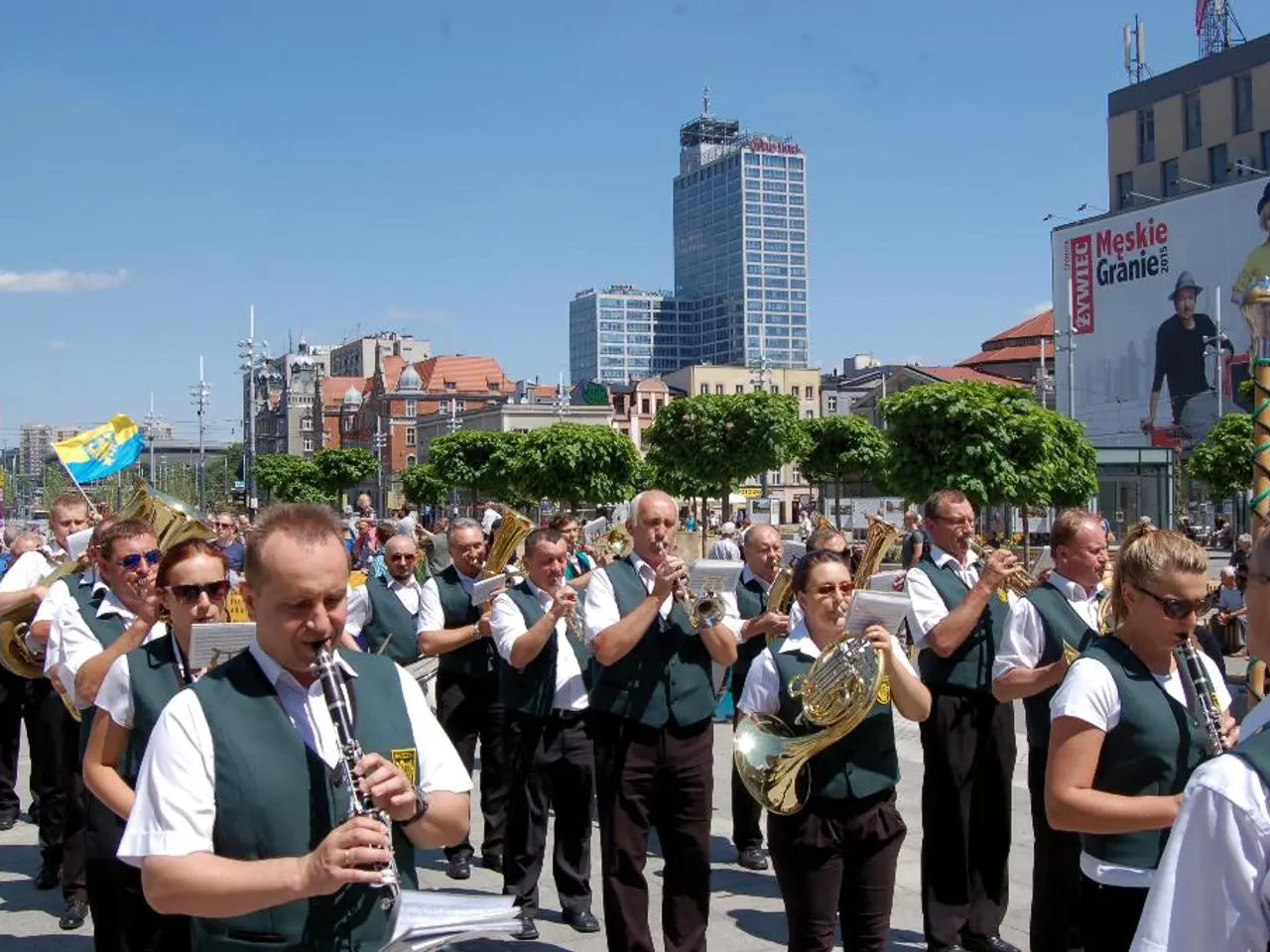 This picture is clicked outside. In the foreground we can see the group of persons wearing same...