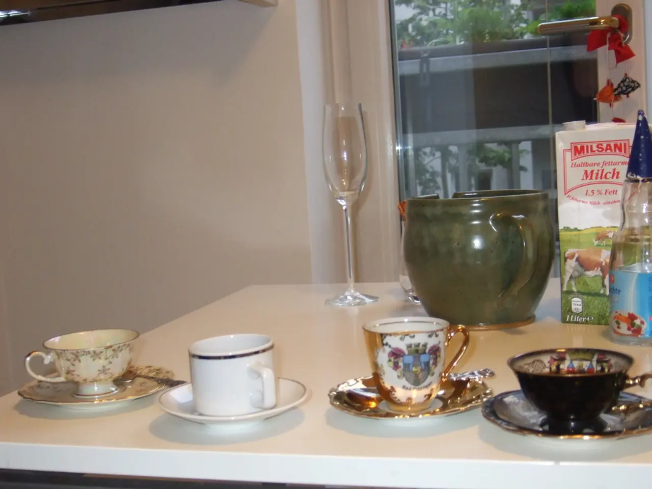 In the image we can see there is a table on which there are cups and saucers on the table and there...