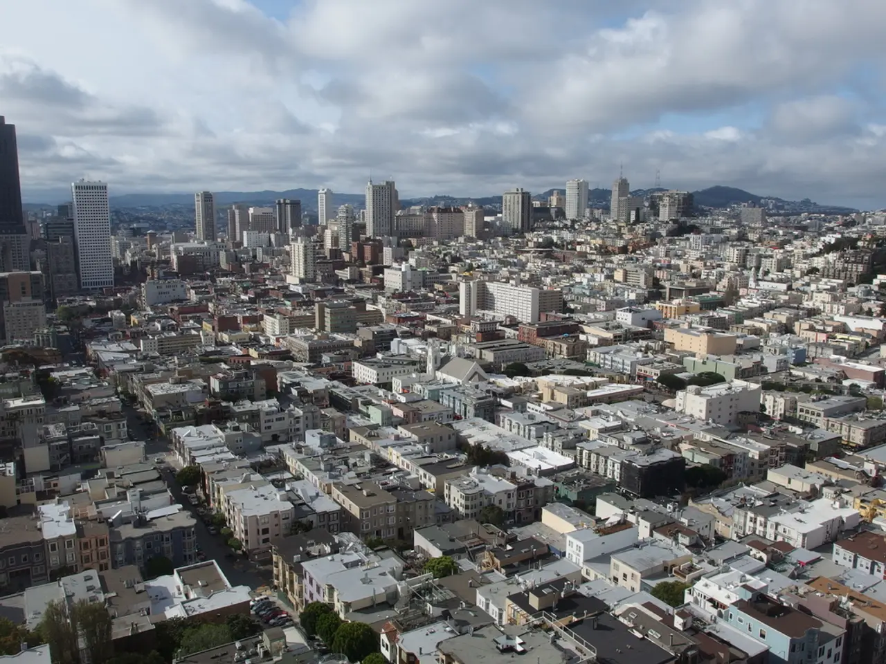 It is an image of a well developed city, there are plenty of houses, buildings and tall towers,...