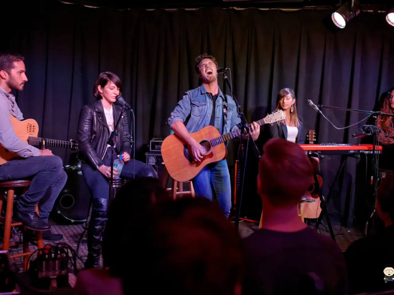 There are five members in this stage. Two of them were playing guitars in their hands and remaining...