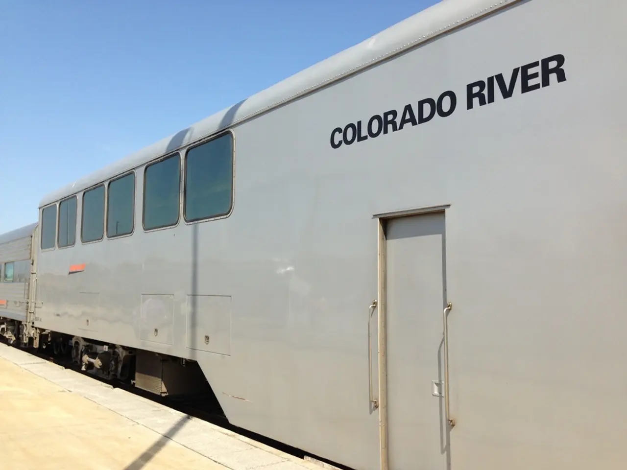 In this picture we can see a train, and we can find text on the train.