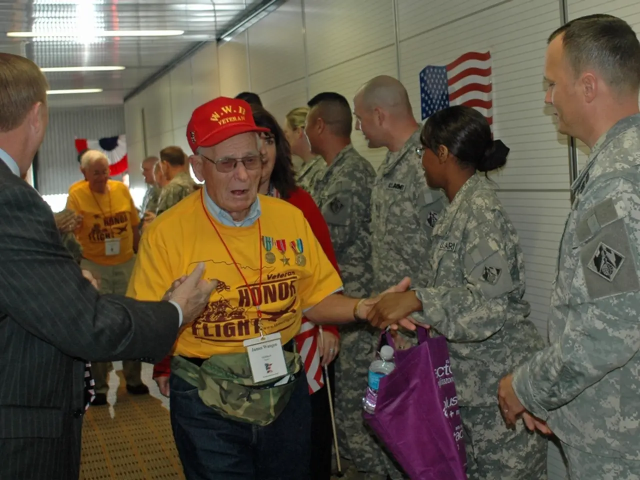 In this picture there are people and soldiers. On right to the wall there is flag. At the top to...