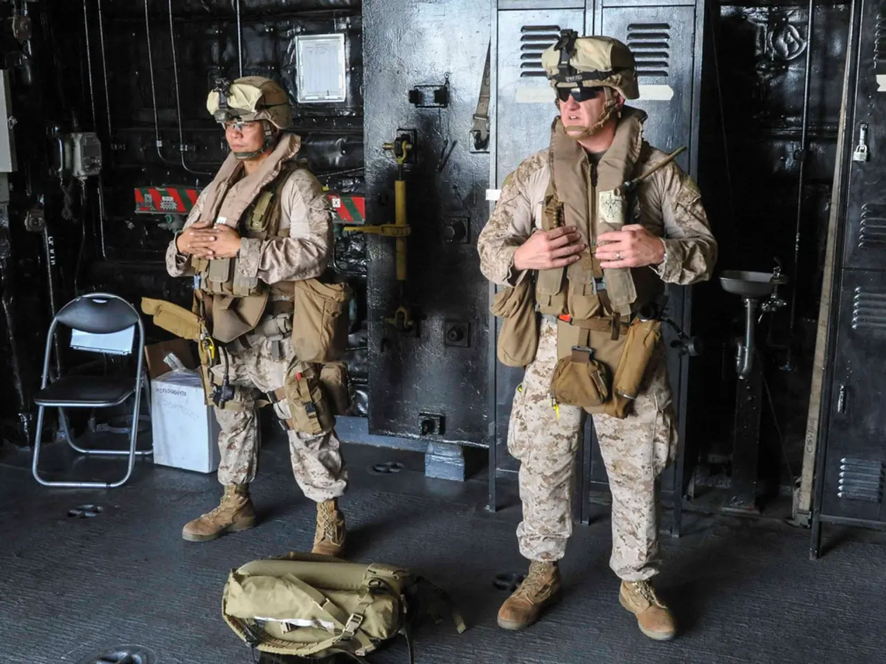 In this picture there are two soldiers standing and there is a bag in front of them and there is a...