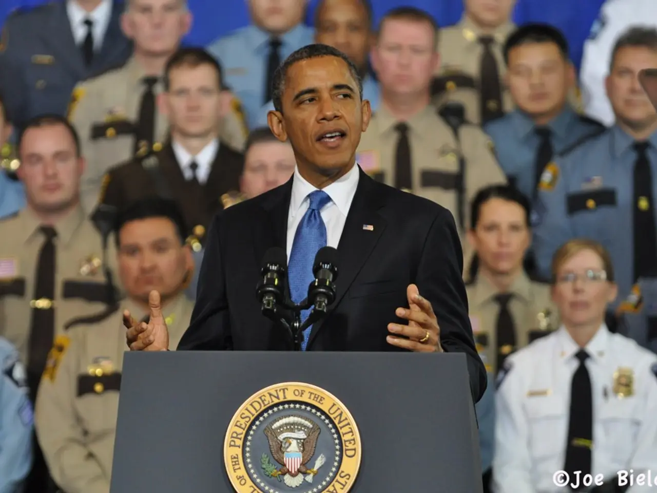 In this image there is a podium towards the bottom of the image, there is text on the podium, there...