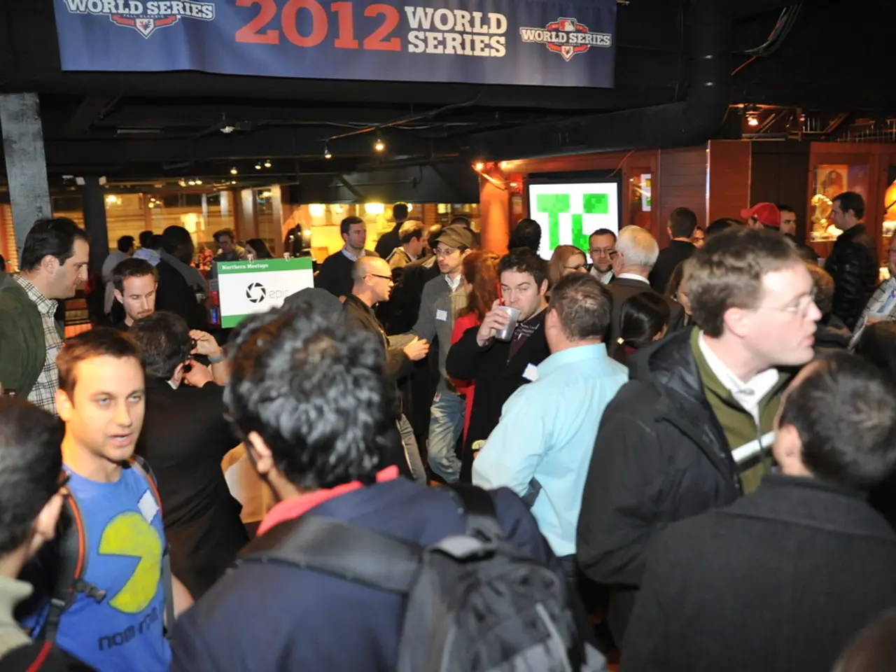 In the picture there is a huge crowd and it looks like some event, behind the people on the right...