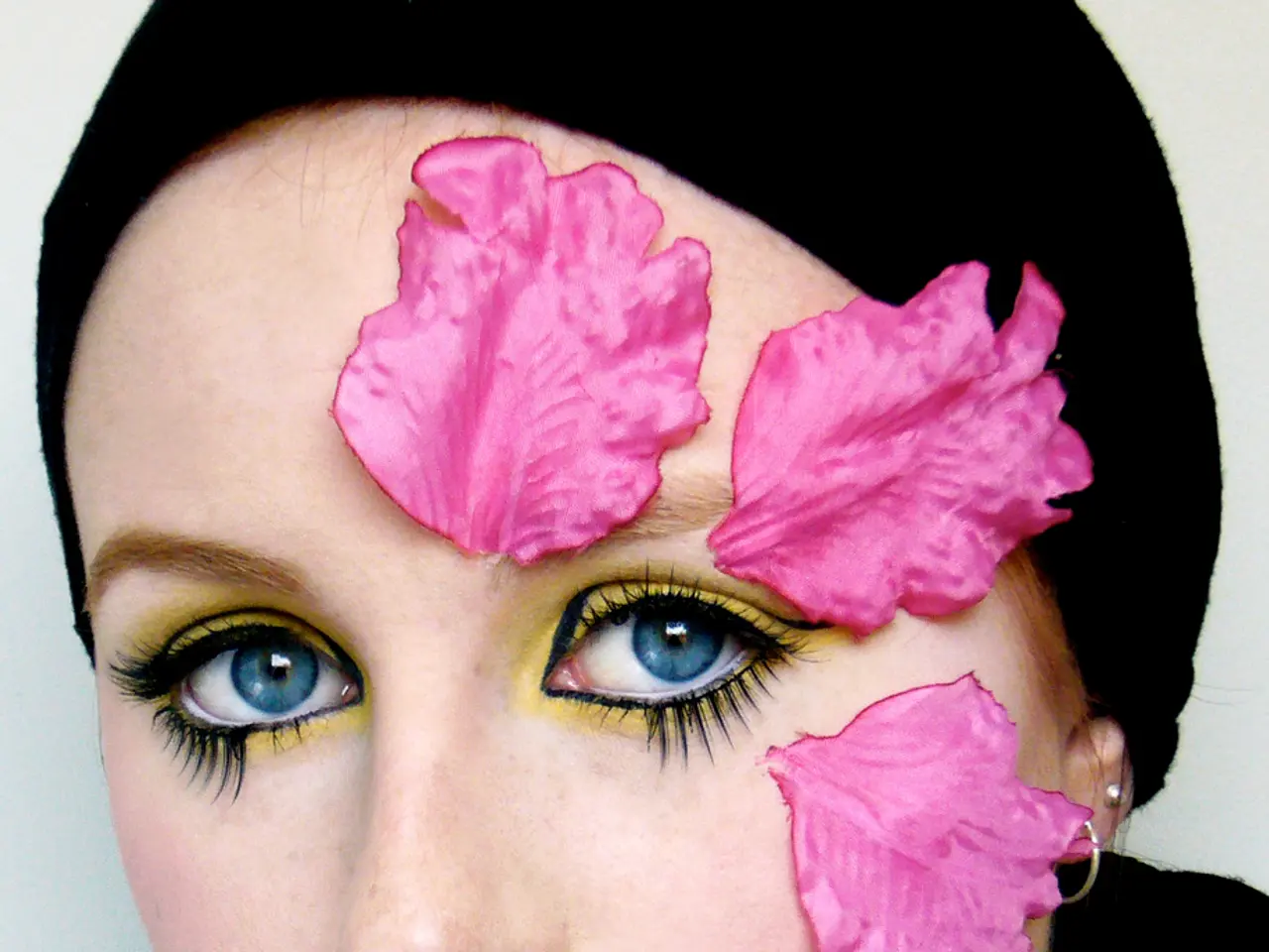 In this picture I can see a woman with different makeup.