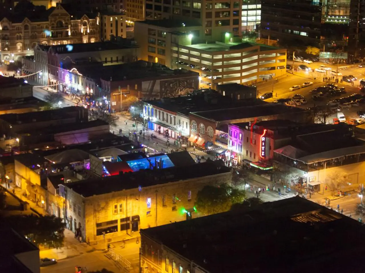 This image is taken outdoors. In this image there are many roads. Many people are walking on the...