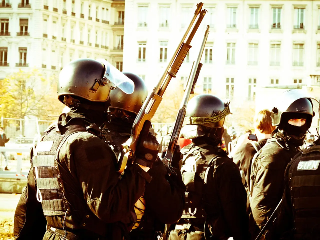 In this image I can see few persons wearing uniforms and helmets are standing and holding guns in...