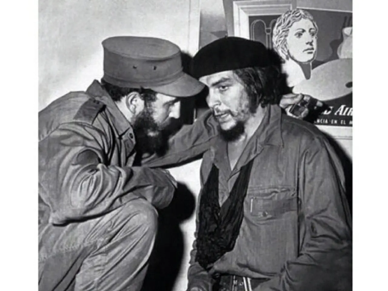 In this picture we can see two famous personalities talking with each other. In the background we...