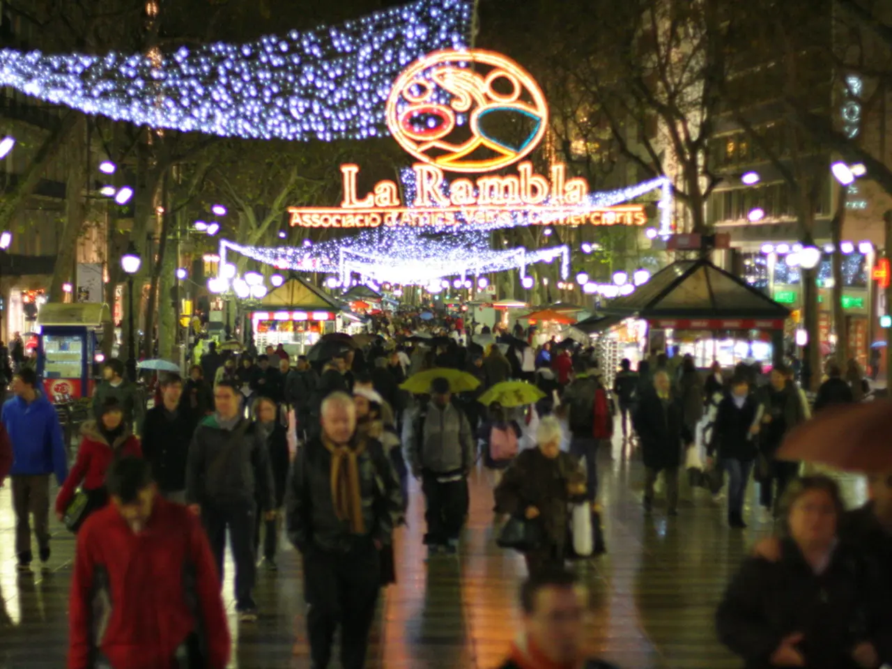 In this picture we can see there are groups of people on the walkway. Some people holding the...