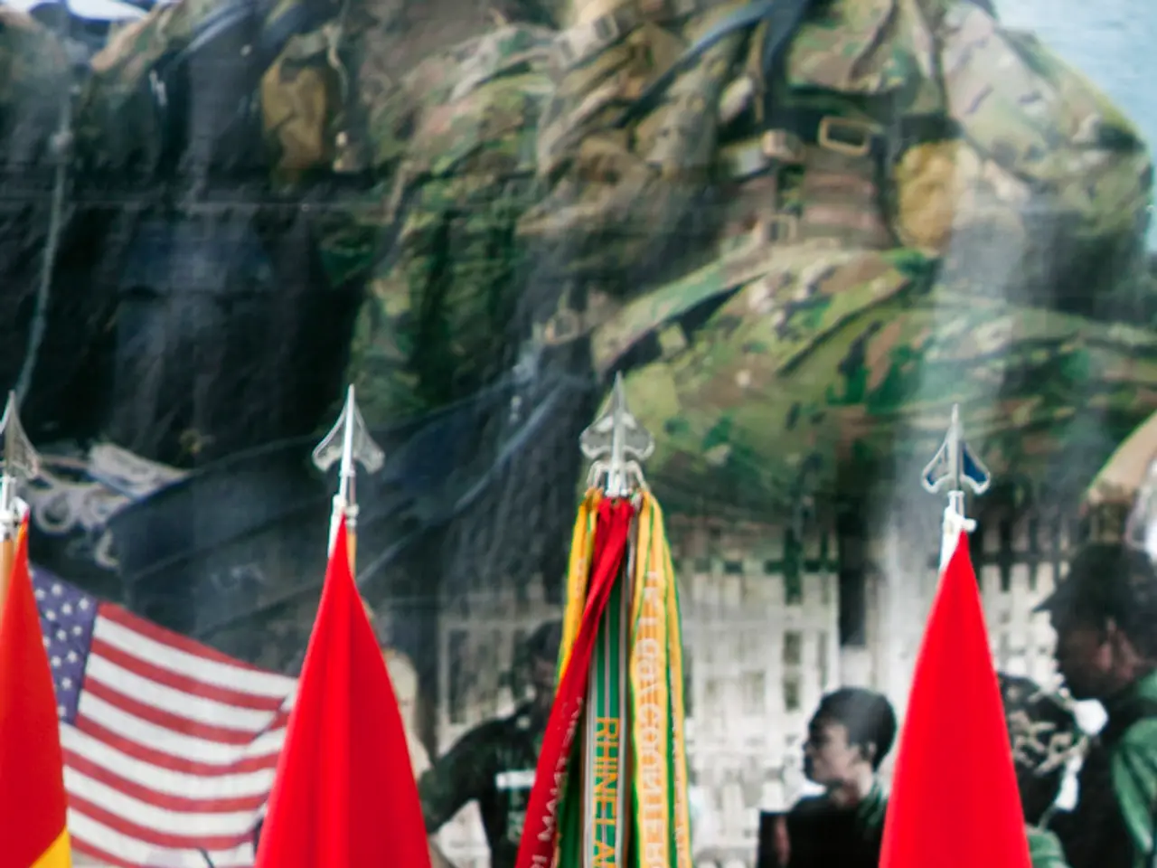 In this image we can see an army man standing in front of the podium. We can also see the mike. In...