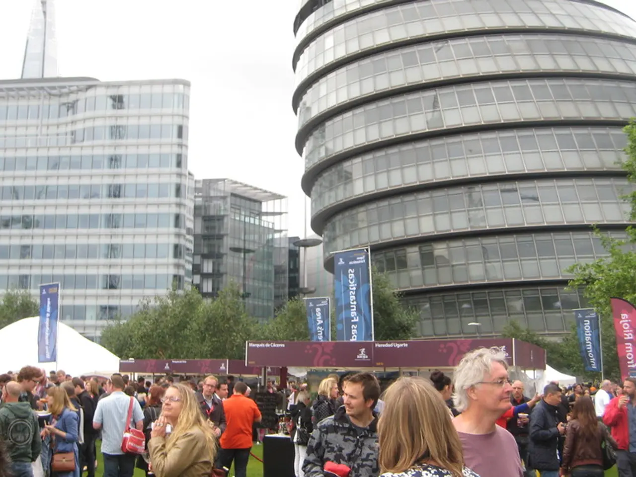 In the image there are many huge buildings and in front of those buildings there are few trees and...