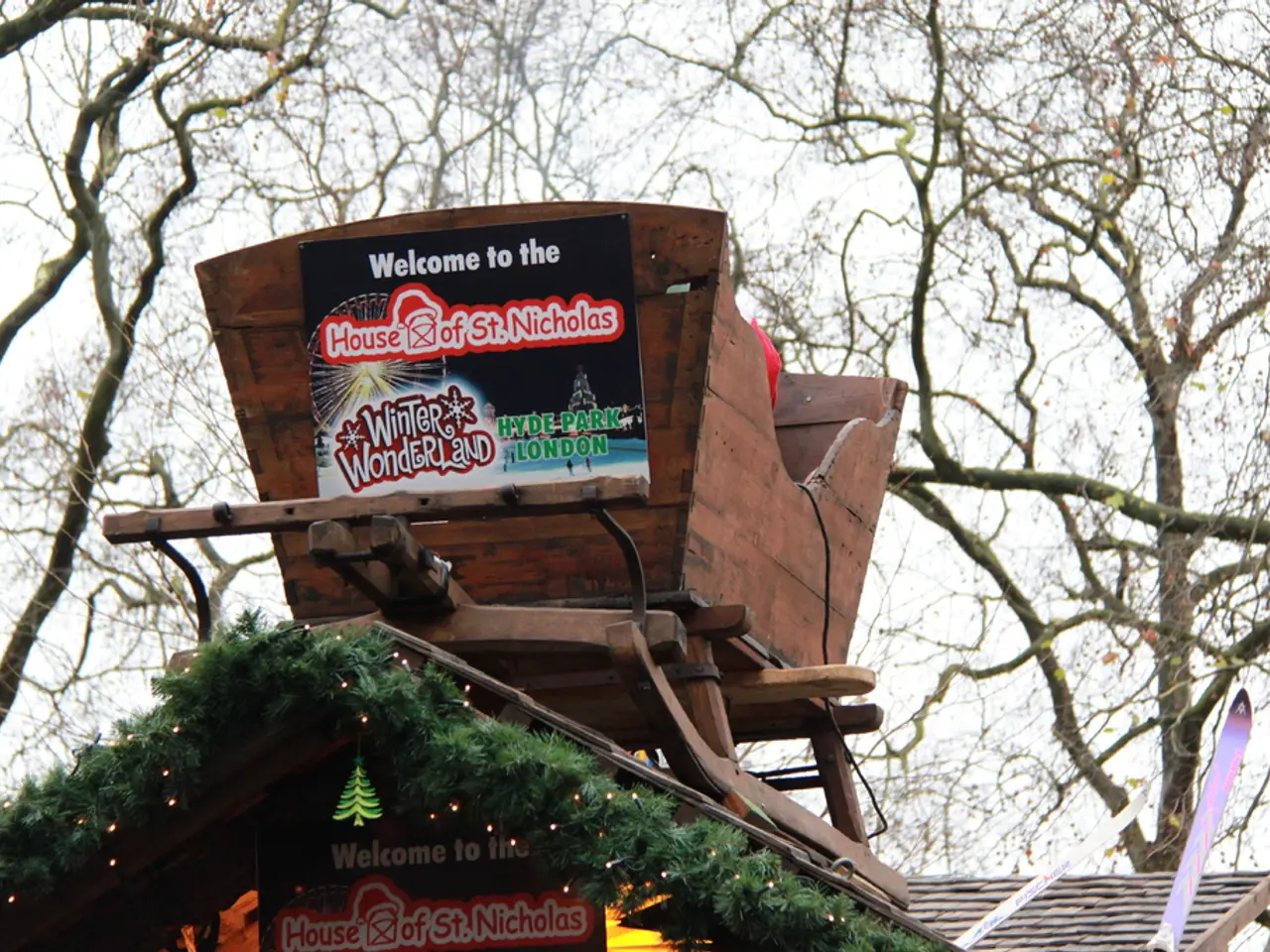 In this image we can see a wooden house with boards and there is some text on them. In the...