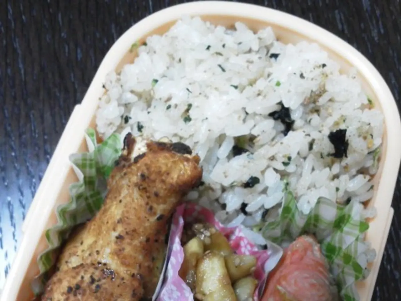 In this picture we can see box with tomatoes, food and papers on the wooden platform.