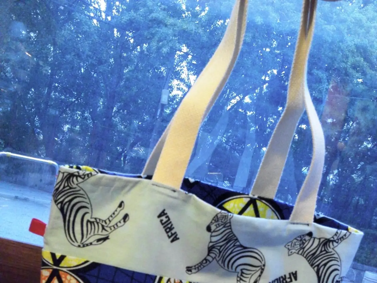 In this background there are some trees and there is a road ,in front of road there is a table ,on...