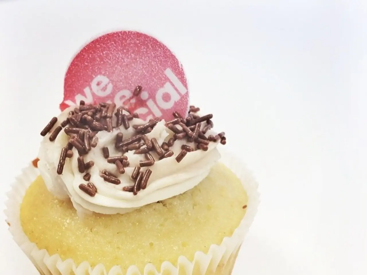 In the image there is a cupcake and on the cupcake there is some cream.