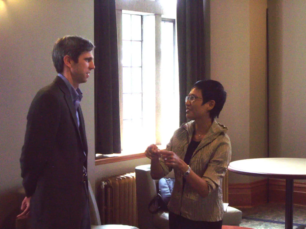 This is a image clicked inside the room. Here I can see a woman is telling something to the man who...