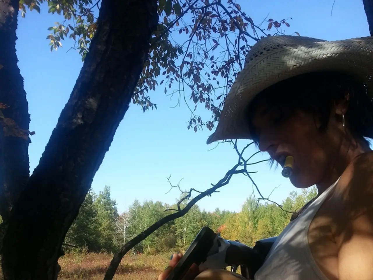 In this image in the center there is one woman who is standing and she is holding a gun, and in her...