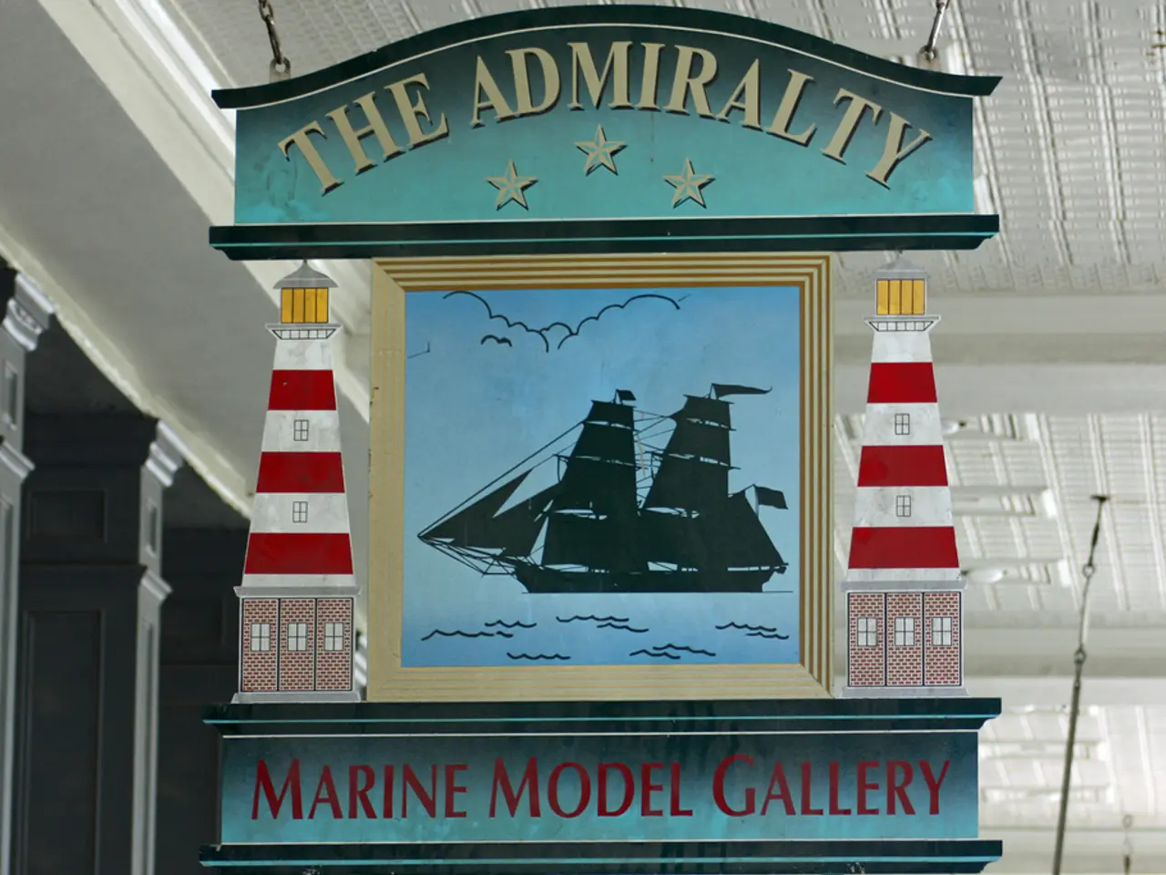 In this picture I can see there is a board attached to the ceiling and there is a ship and there...