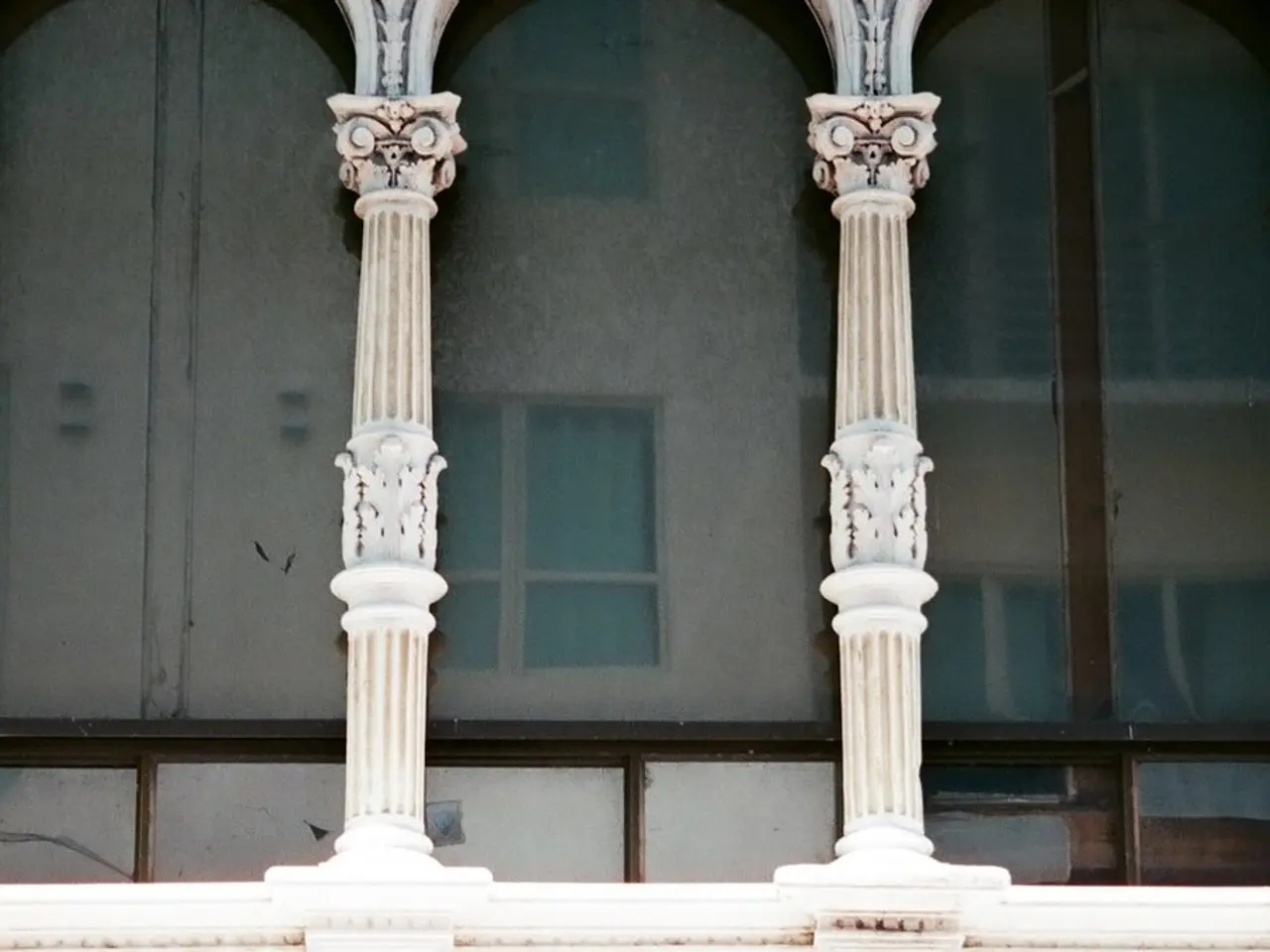 This image consists of a building. It has windows and pillars.