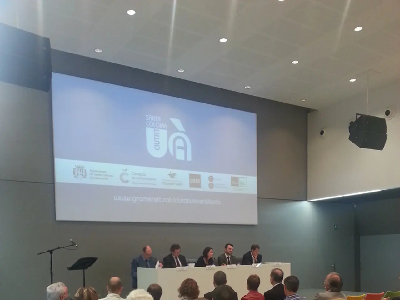 It is like a seminar hall, group of people are sitting on the chairs, opposite to them there is a...