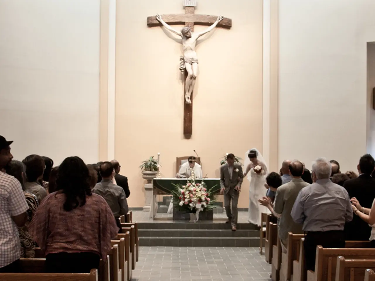 In this image we can see there are few people attending the ceremony of a newly wed. In the...