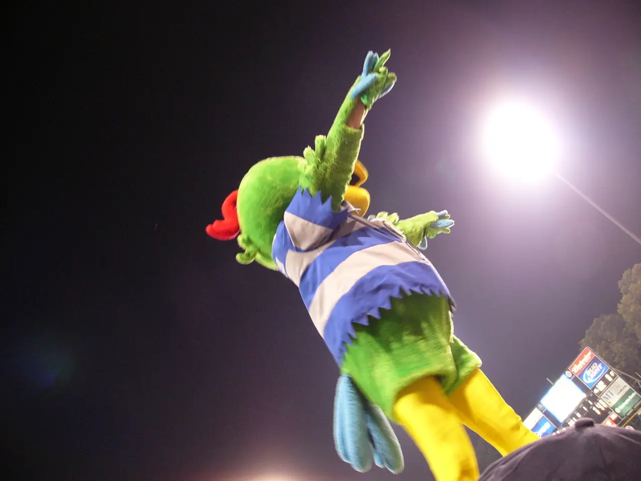 In this image there is a person wearing a mask. He is wearing a costume. Right bottom there is a...