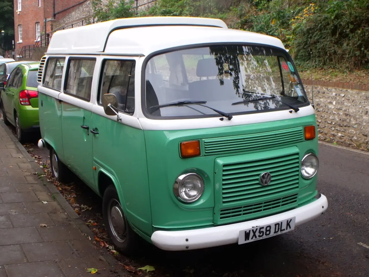 In the image I can see the road, few vehicles on the road and the sidewalk. In the background I can...