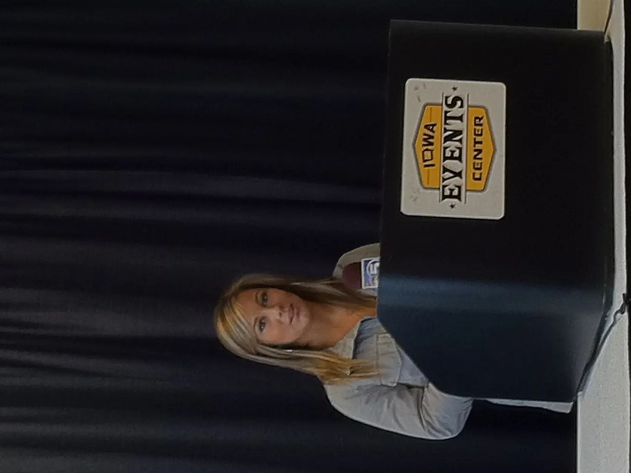 This picture is in leftward direction. At the bottom, there is a woman wearing a blue shirt and...