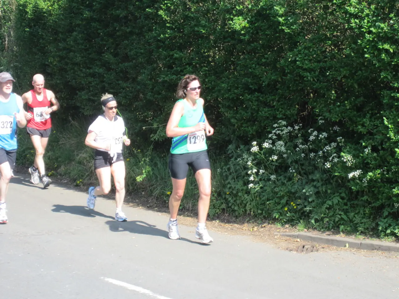 This is the picture of some people who are on the road and around there are some plants and trees.