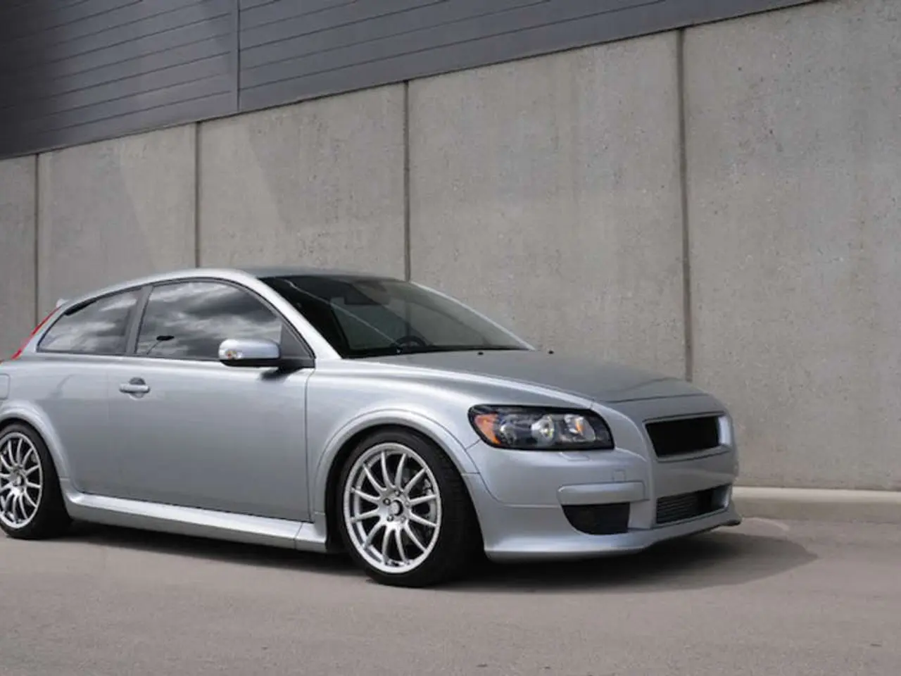 It is a car in silver color and this is the wall.