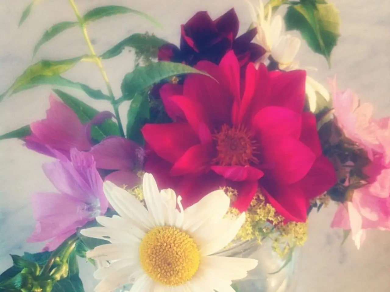 In the center of the image a flower pot is there. In the background of the image floor is present.