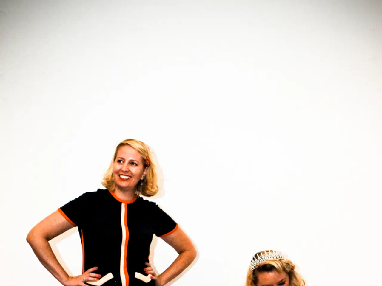 This woman wore black dress and giving still. This woman is sitting on a bench and looking at this...