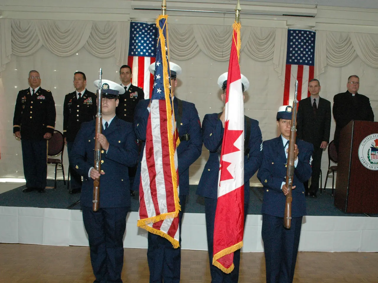 In this image we can see four persons wearing caps and also the suits and standing on the floor and...