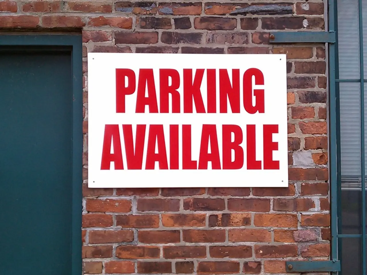 In this image I can see there is a board placed on the brick wall and there is something written on...