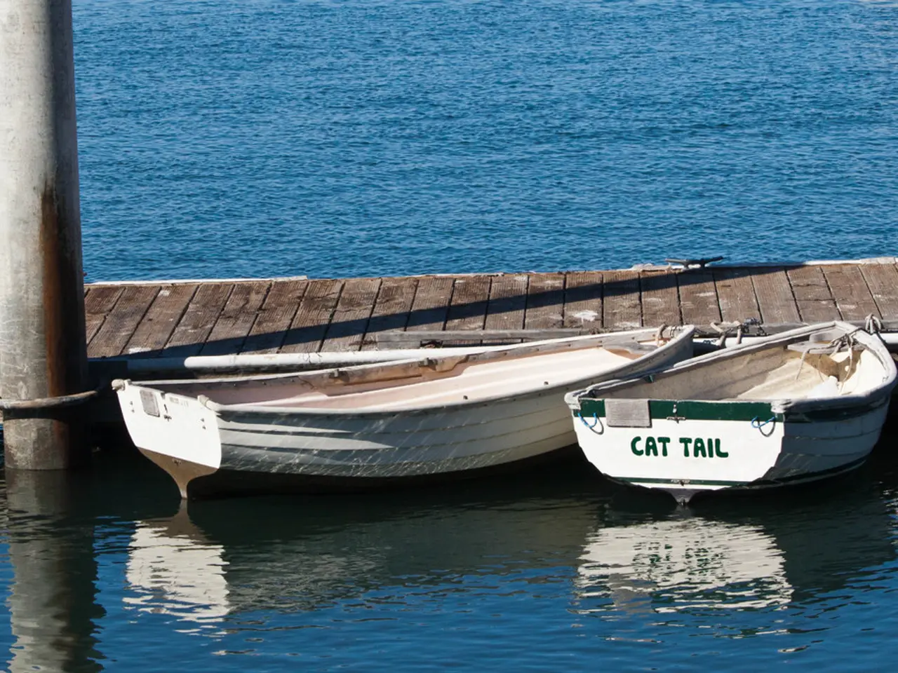 In this image we can see the two boats on the surface of the river. We can also see a pole and also...