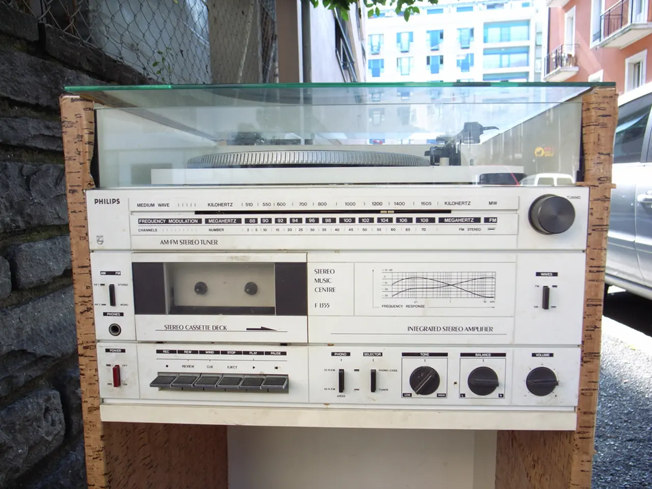 In this picture I can see the radio which is kept on the table, beside that I can see the brick...