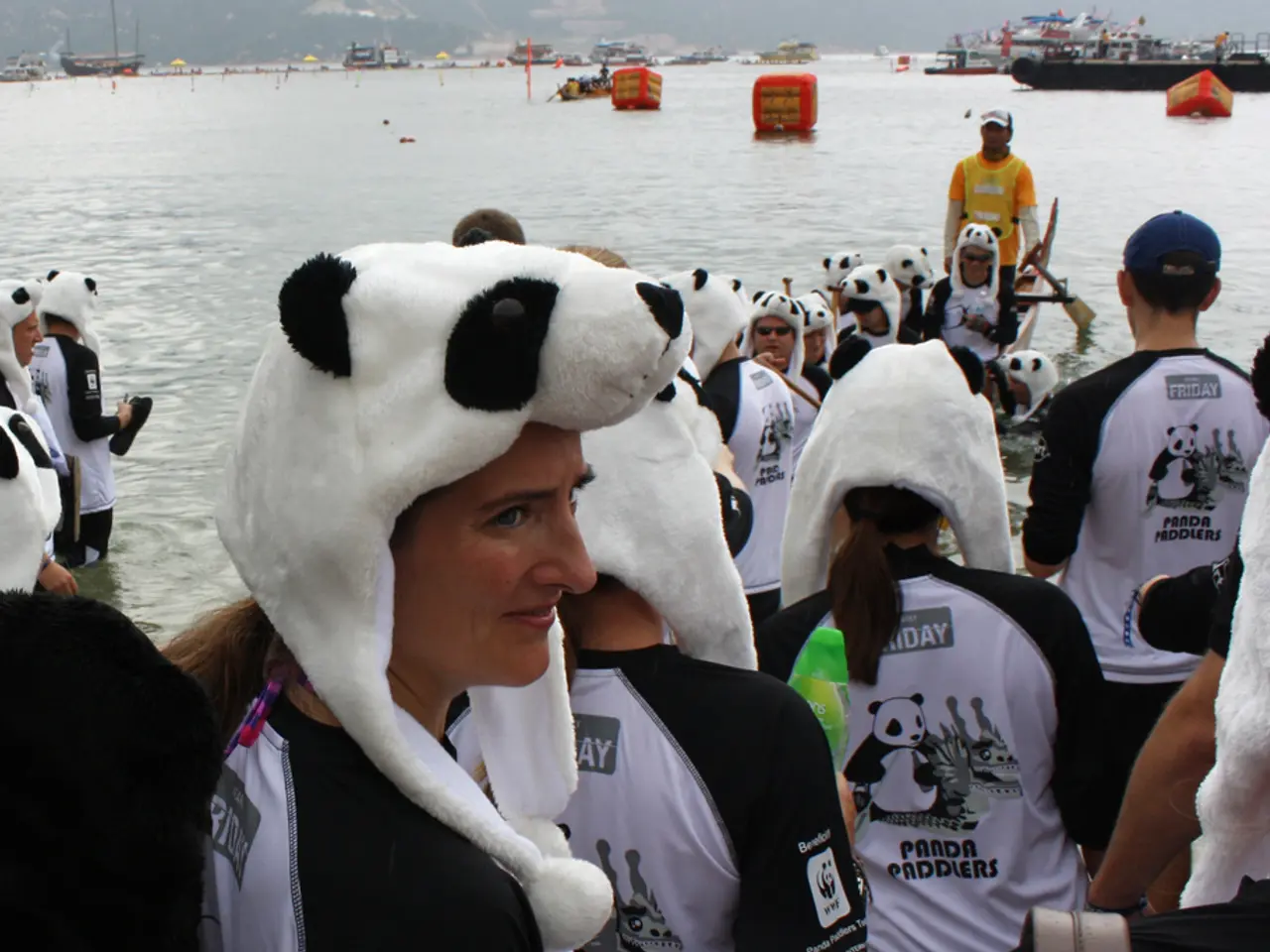 In this picture I can see there are few people standing here and they are wearing panda caps and...