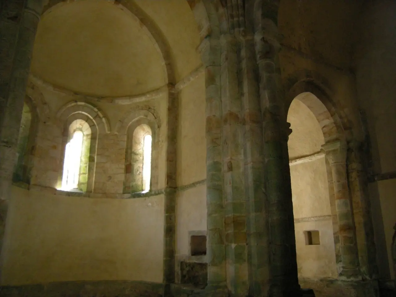 In this picture I can see the pillars and the walls, on the left side there are windows, it looks...