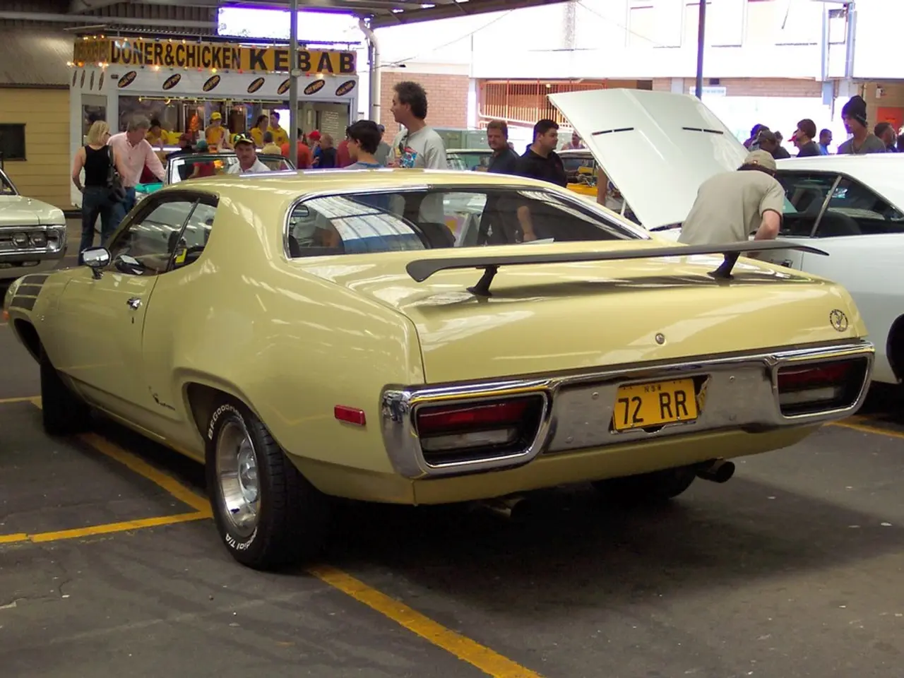 Here in this picture we can see vintage cars present on the road over there and we can see people...