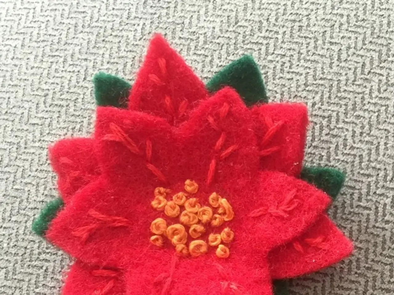 In this image we can see made by woolen placed on the carpet on the floor.