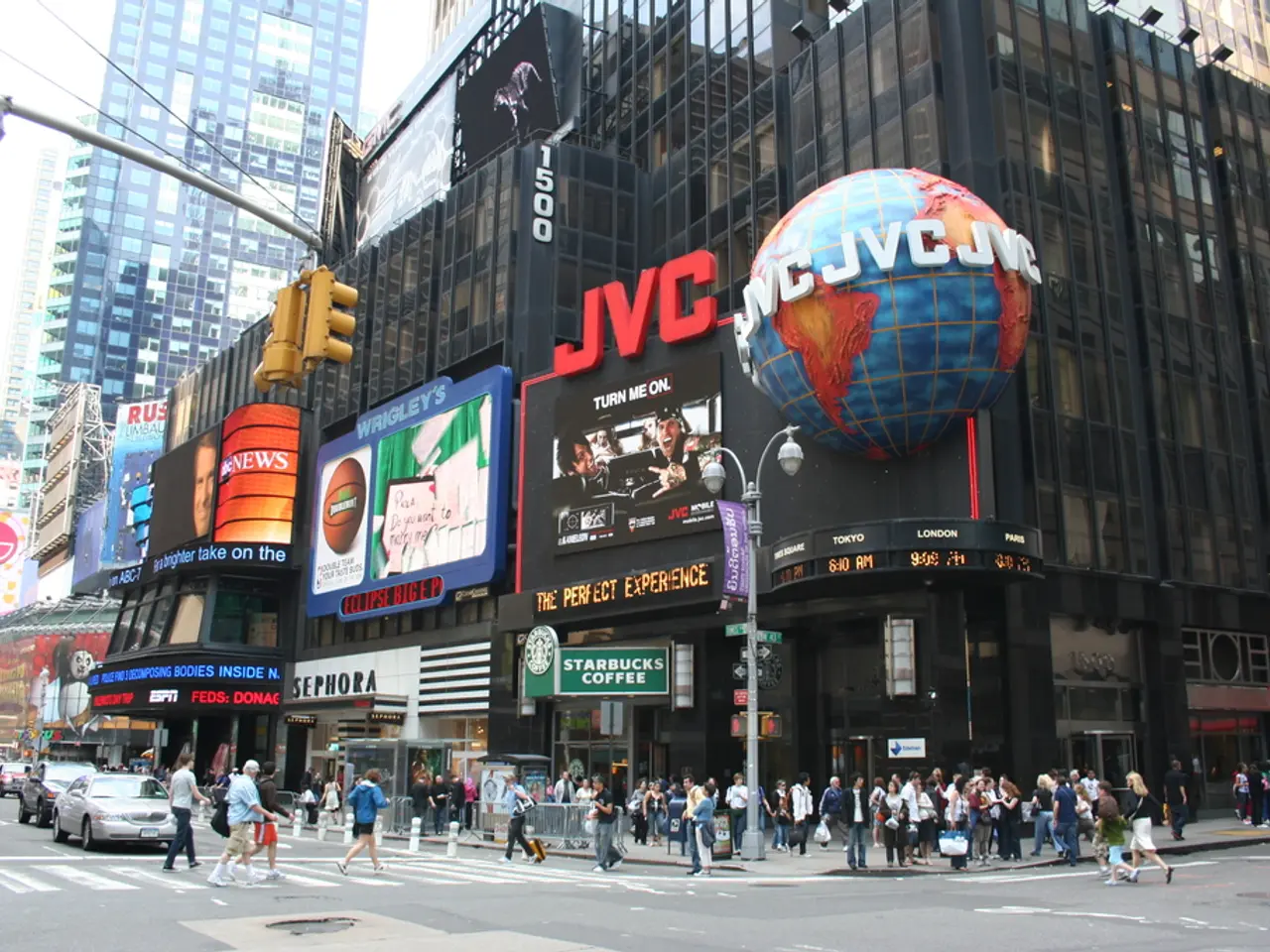 In this picture we can see cars and a group of people walking on the road, pole, buildings, traffic...