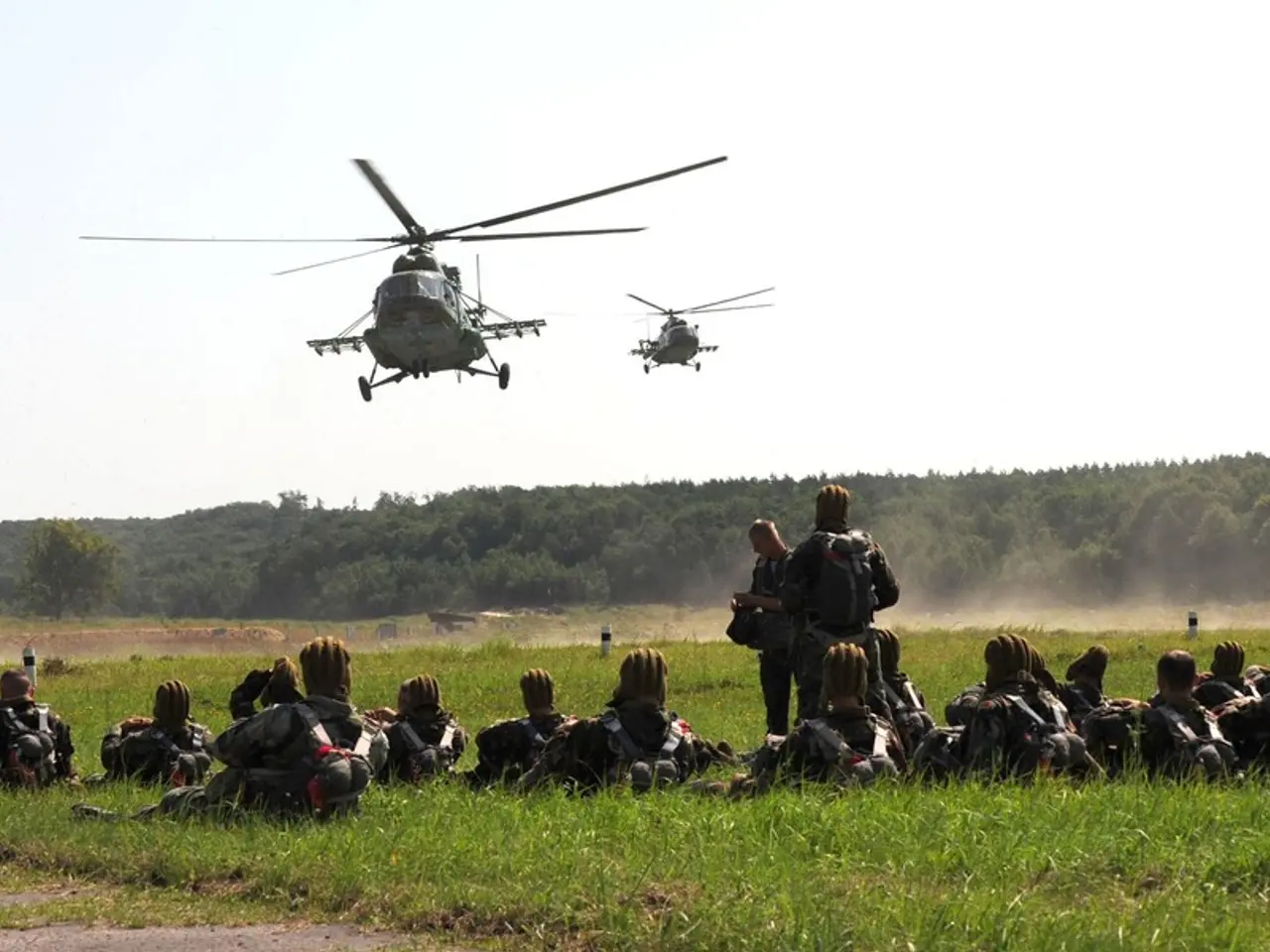 In the image we can see there are people sitting on the ground and they are carrying bags. There...