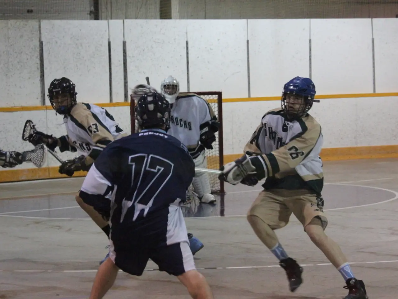 In this image in the center there are some people who are wearing helmets, and holding sticks it...