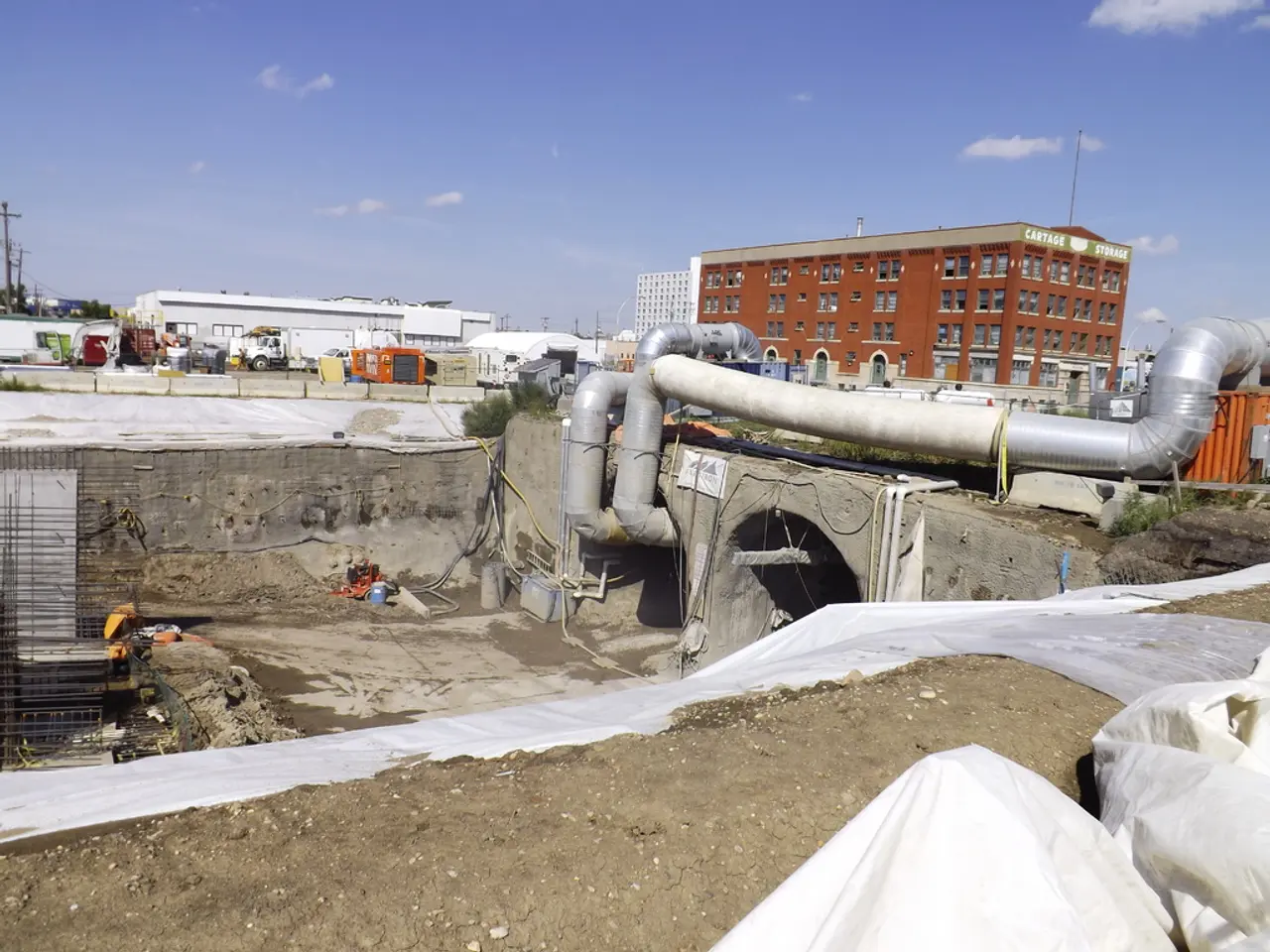 As we can see in the image there are buildings, fence, vehicles, current polls, pipe and on the top...