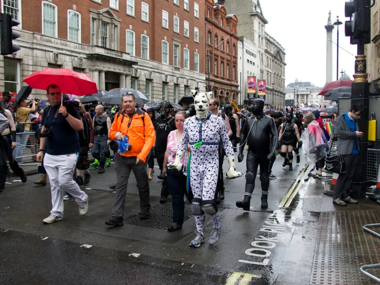 The picture is taken on the streets of a city. In the center of the picture there are people...